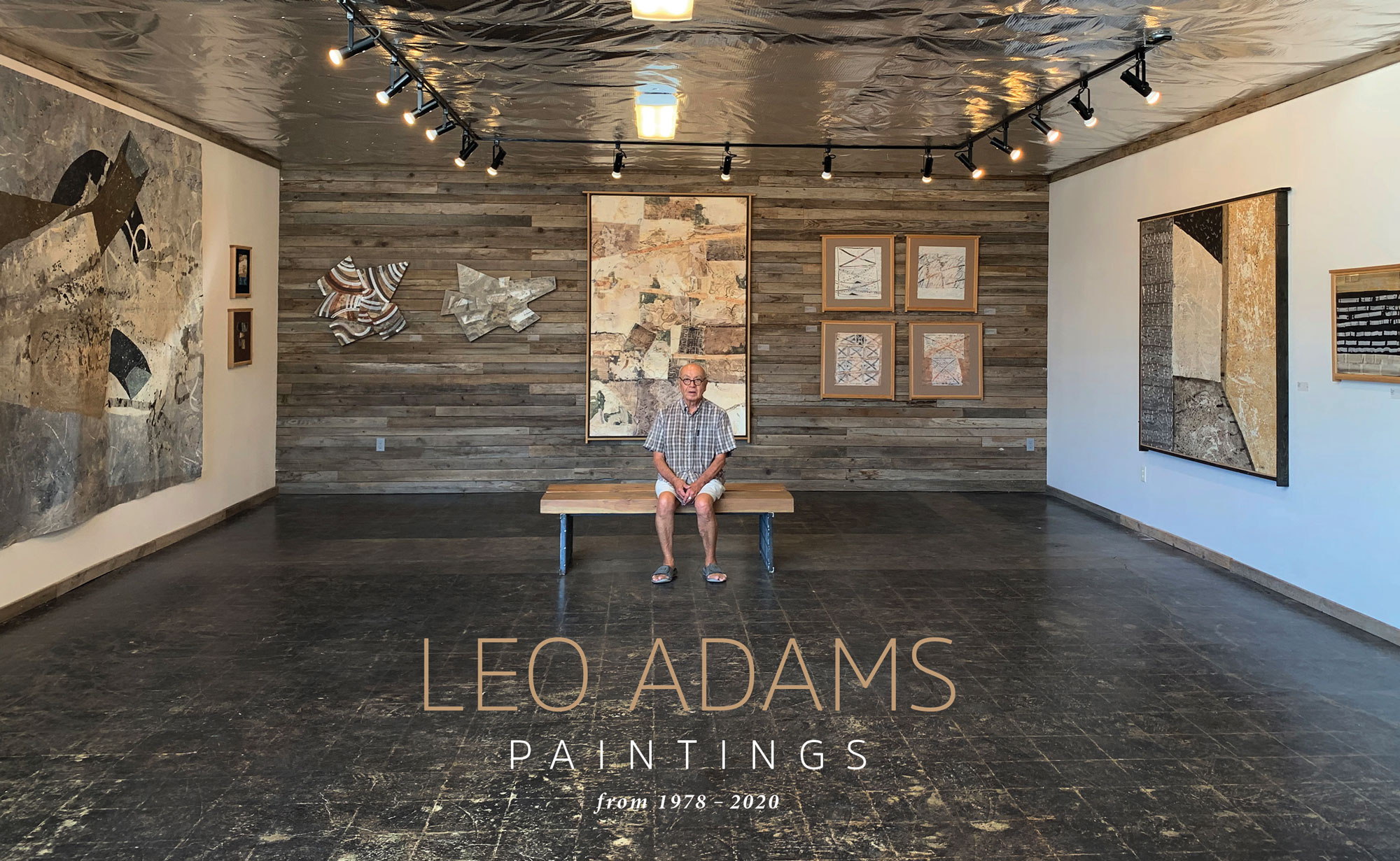 Leo Adams the artist sitting in Boxx Gallery